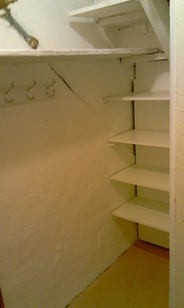 understaircupboardshelvescoathooksandpainting.jpg